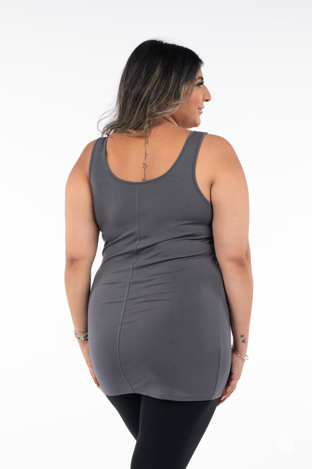 Plus-size woman modeling SweetLegs Canada Classic Layering Tank in grey showing back view with black leggings on white background