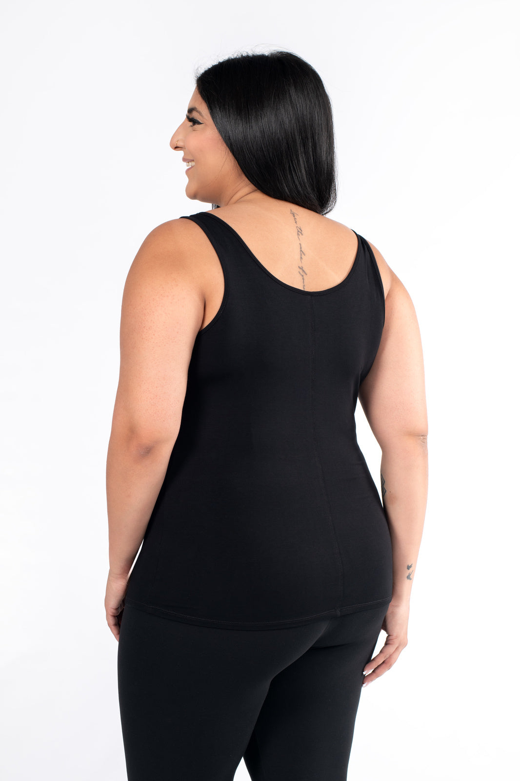 Plus-size model shown from back wearing SweetLegs Canada Classic Tank in black paired with black bottoms on white background