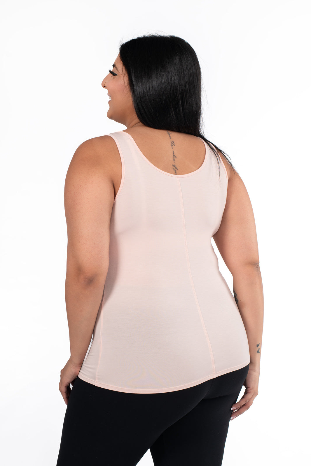 Plus-size model showing back view of SweetLegs Canada Classic Tank in latte paired with black leggings on white background