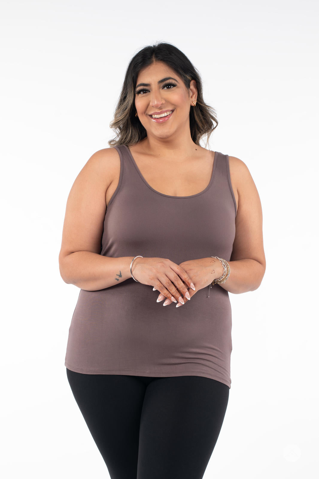Plus-size woman smiling wearing SweetLegs Canada Classic Tank in brown with black pants on white background