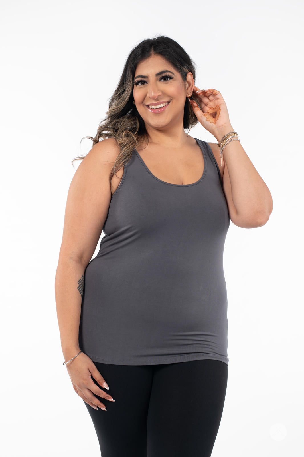 Smiling woman wearing SweetLegs Canada Classic Tank in grey with black leggings on white background