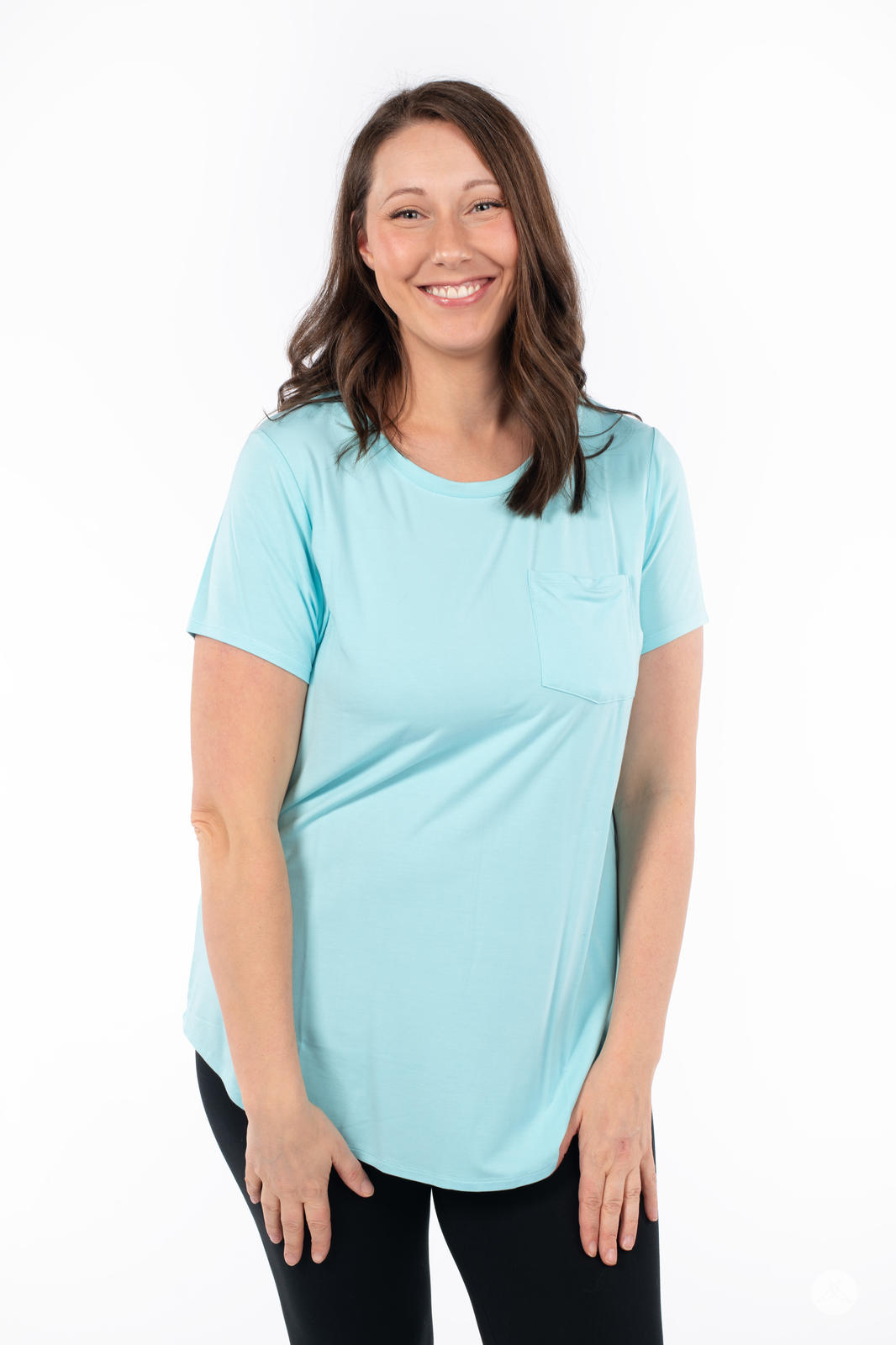 Smiling woman wearing SweetTops Crew Neck Pocket Tee in paradise blue with short sleeves and relaxed fit style