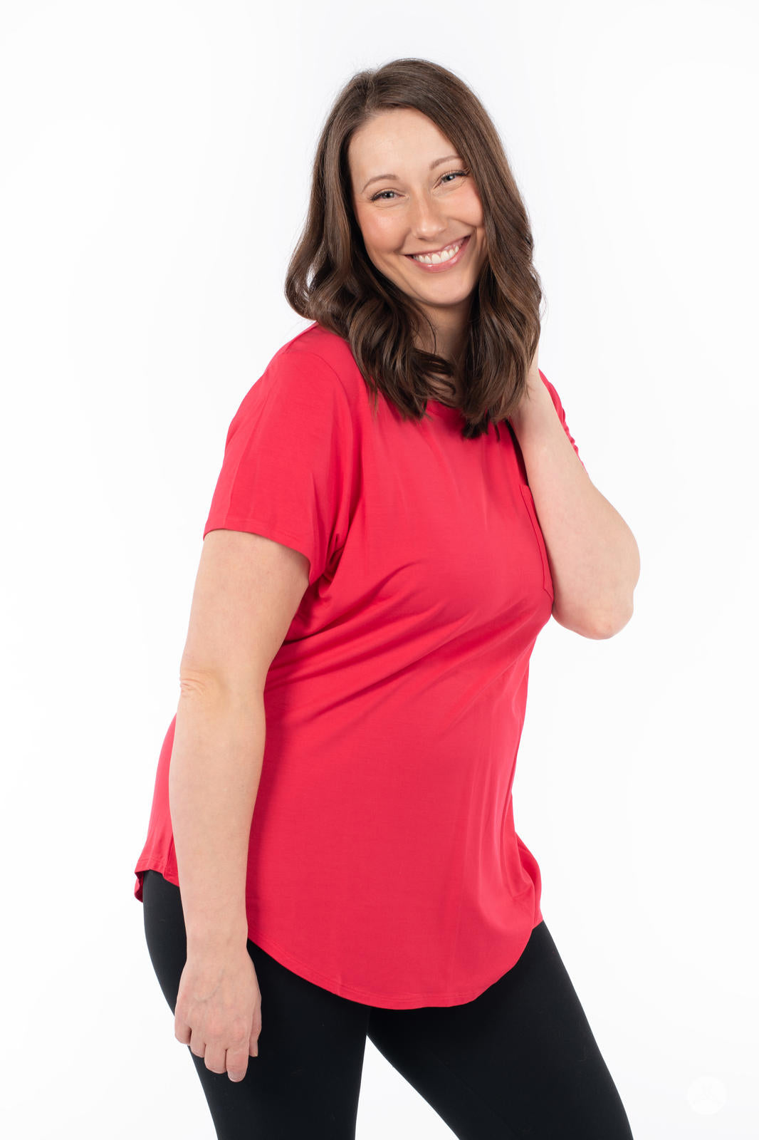Smiling woman wearing SweetTops Crew Neck Pocket Tee in vibrant red with short sleeves and relaxed fit