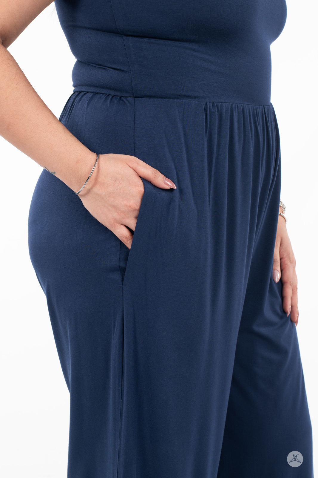 Close-up of hand in pocket on navy blue SweetLegs Cropped Wide Leg Jumpsuit fabric and waistband detail