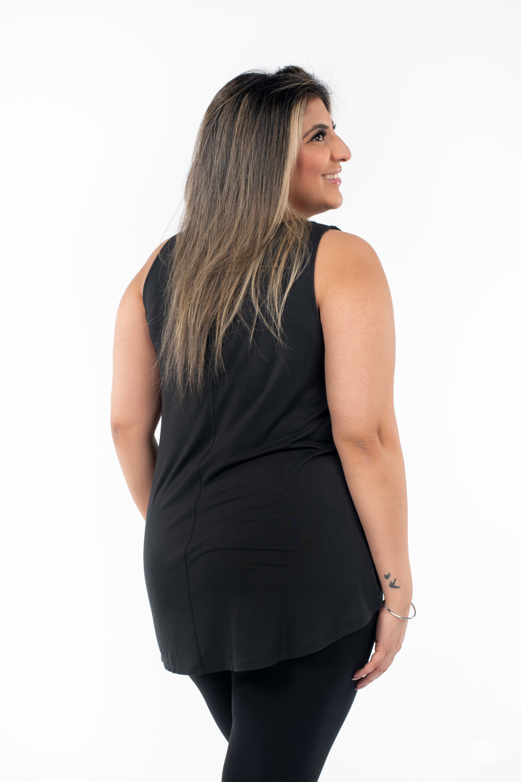 Plus-size model wearing SweetTops High Neck Swing Tank in black shown from back on white background