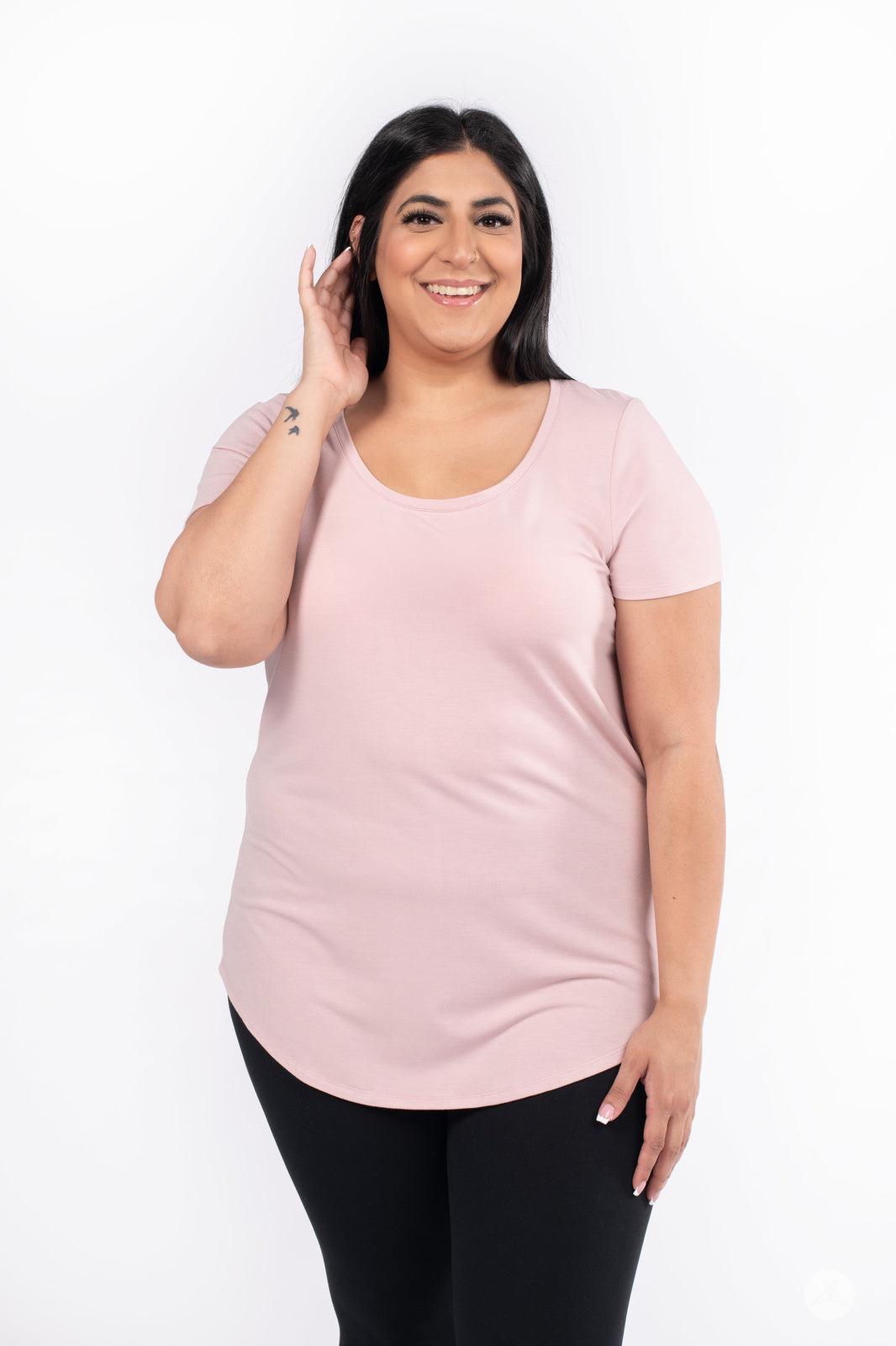 Plus-size front view of woman wearing SweetLegs Canada Scoop Neck Tee with curved hemline in soft pink shade