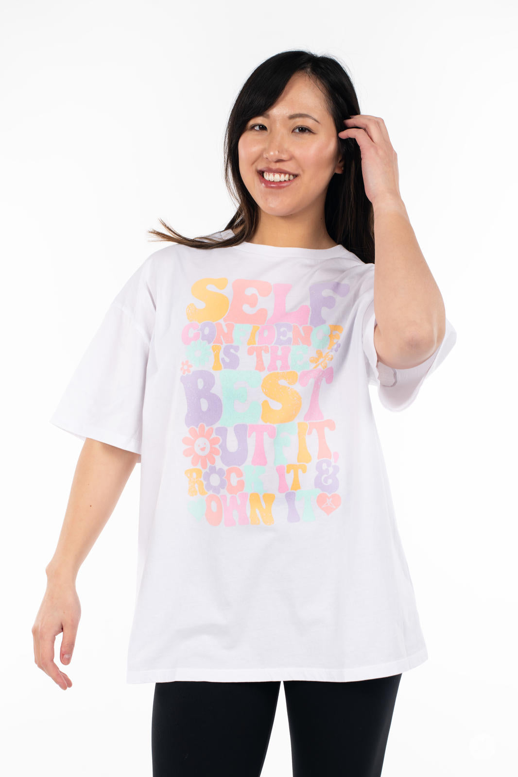 Woman wearing SweetTops Vintage Graphic Tee in white with colorful positive affirmation and floral design