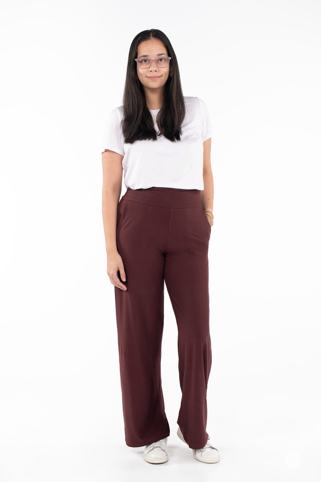 Woman modeling SweetLegs High-Waist Wide Leg Pants in deep brown paired with a white tee and white sneakers on white background