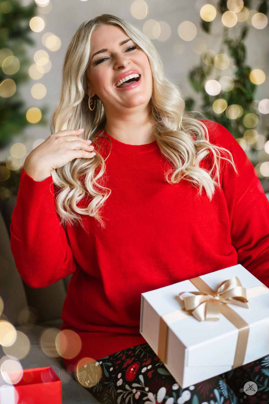 Woman smiling wearing SweetTops Soft Knit Crew Neck Sweater in bright red with long sleeves and relaxed fit holding gift box