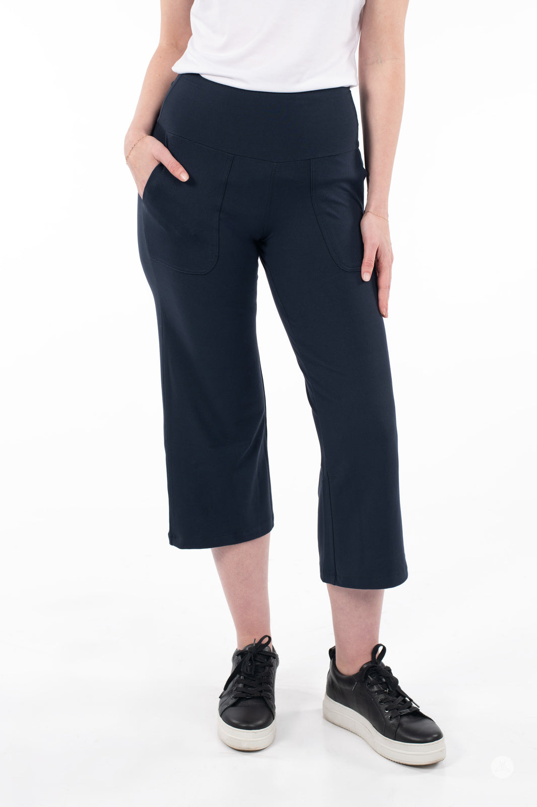 Front view of woman wearing SweetLegs High-Waist Wide Leg Crops in black with black sneakers and white top