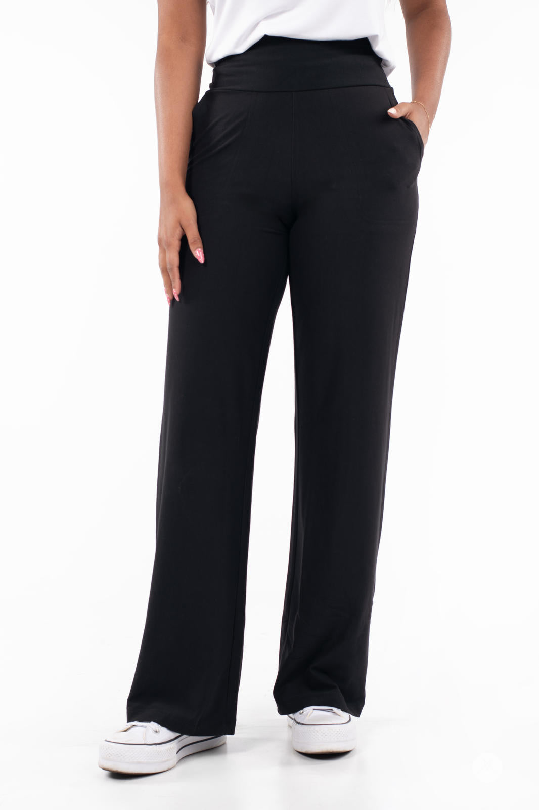 Front view of SweetLegs High-Waist Wide Leg Pants in black with hand in pocket and white sneakers