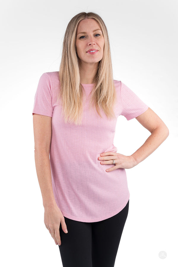 Woman wearing light pink The Soft Ribbed Tee by SweetLegs Canada with short sleeves and curved hem front view