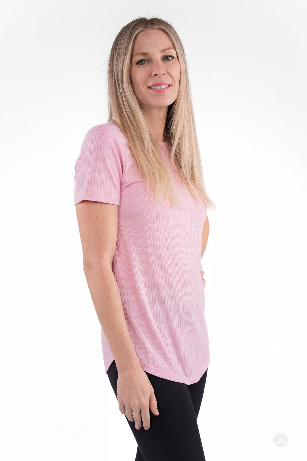 Woman wearing pink The Soft Ribbed Tee by SweetLegs Canada with short sleeves and relaxed fit side view