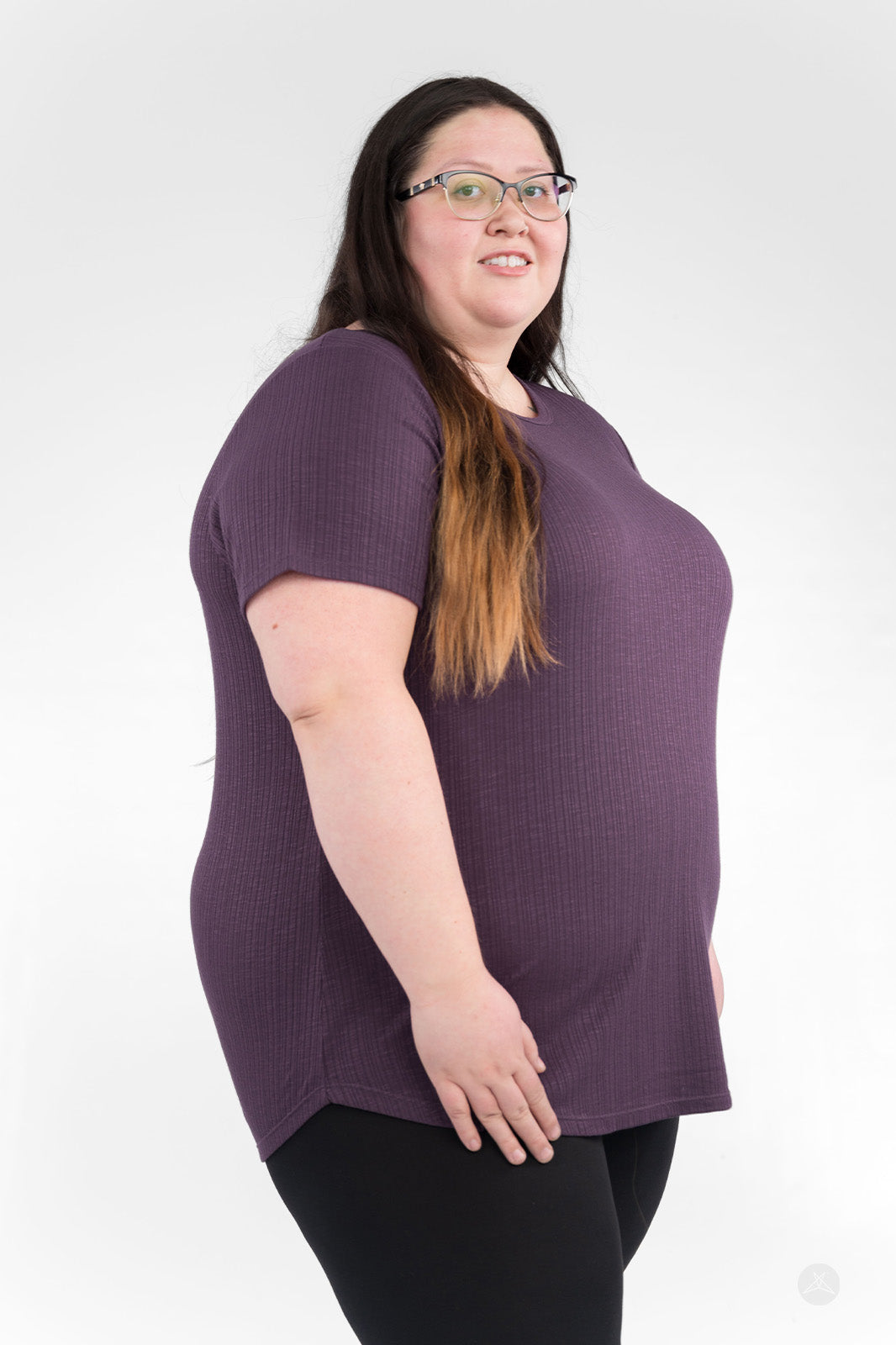 Plus-size woman wearing purple The Soft Ribbed Tee by SweetLegs Canada with short sleeves and crew neck side view
