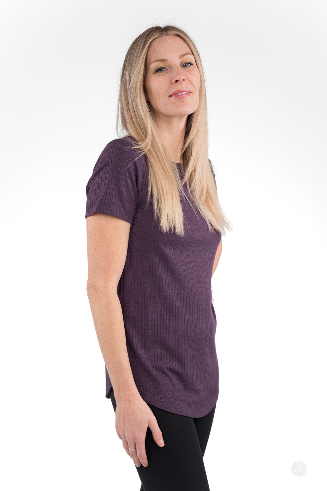 Side view of woman wearing purple The Soft Ribbed Tee by SweetLegs Canada with crew neck and short sleeves