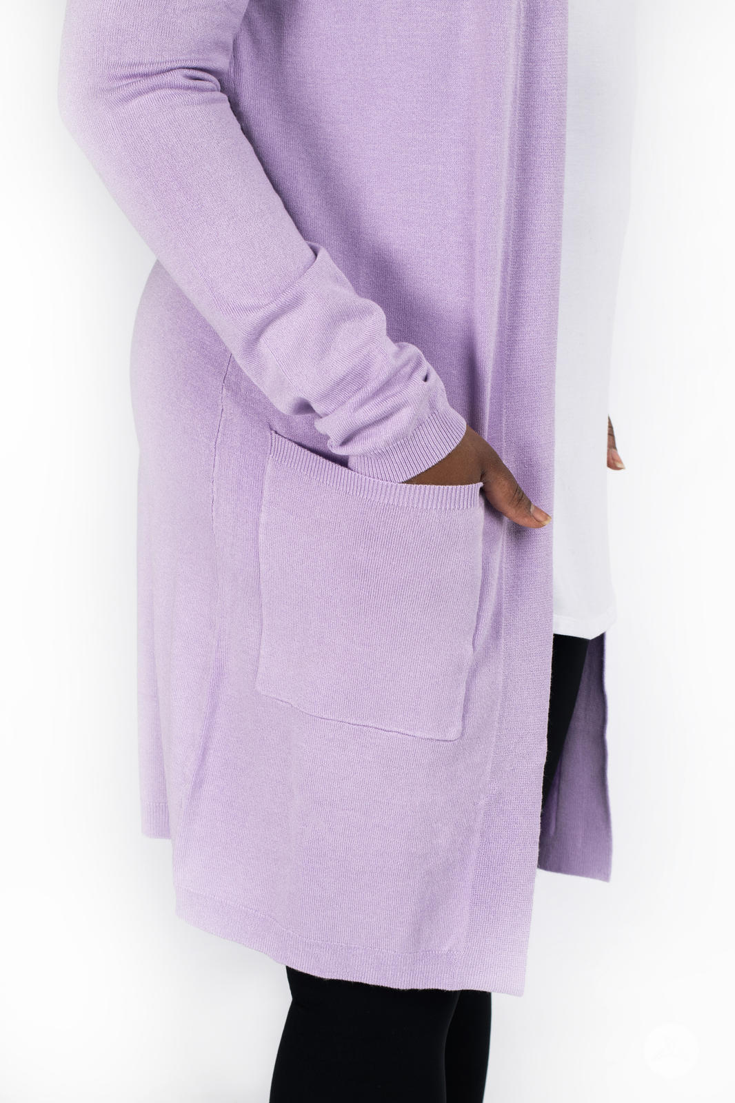 Side view of model wearing SweetLegs Canada Spring Cardigan in soft lavender with front patch pocket over white top