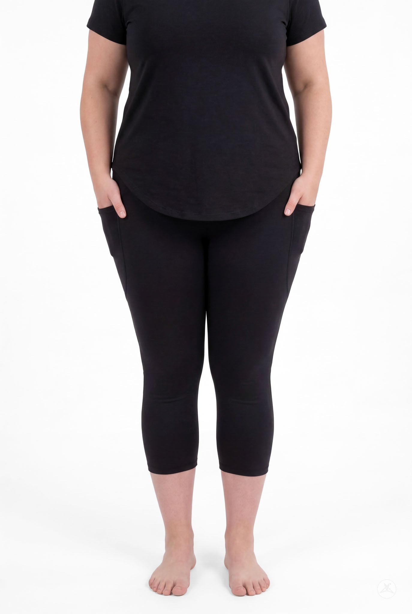 Woman wearing SweetLegs Black Pocket Crops with side pockets and black top standing barefoot facing forward