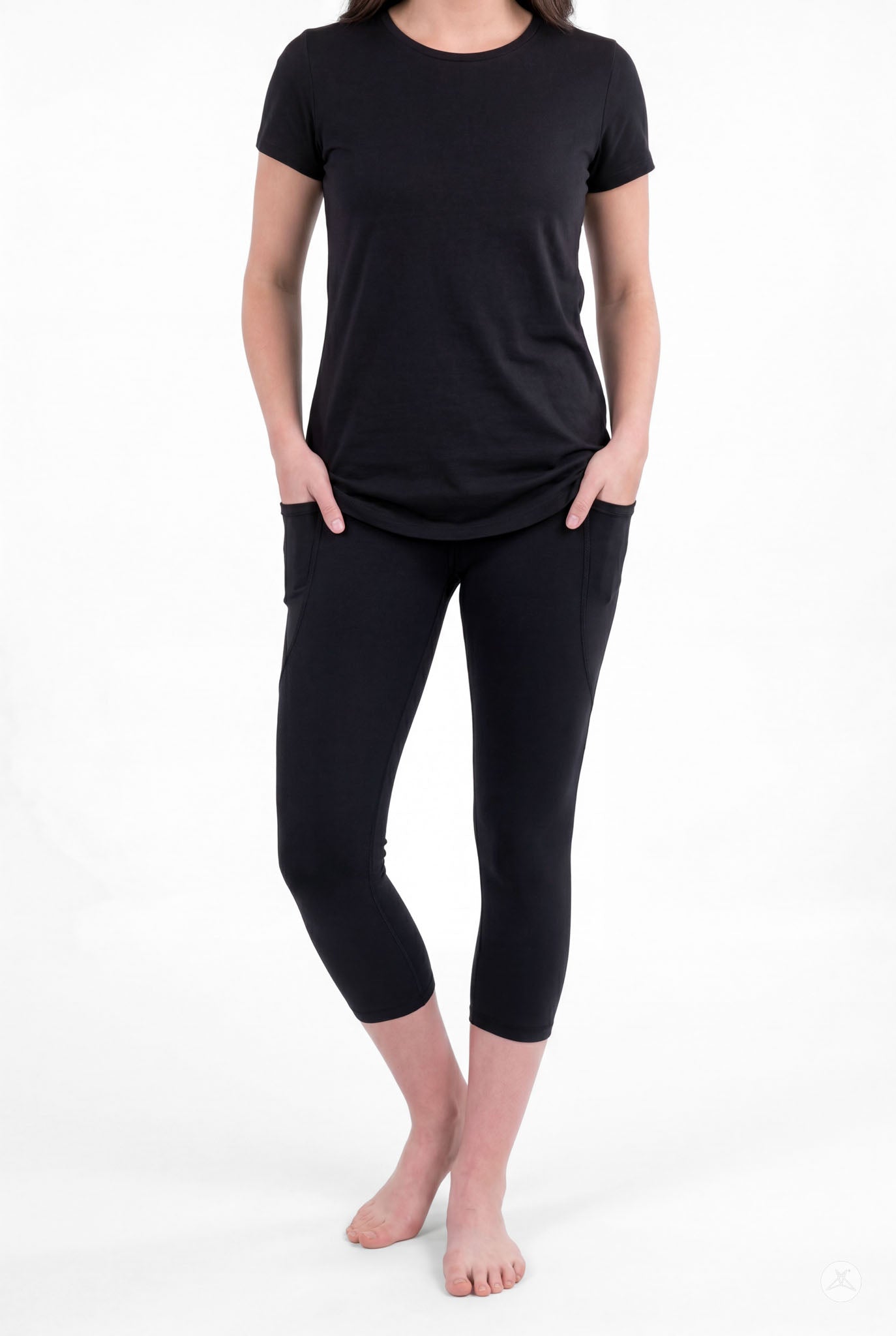 Woman wearing SweetLegs Black Pocket Crops with side pockets and black short sleeve top barefoot front view