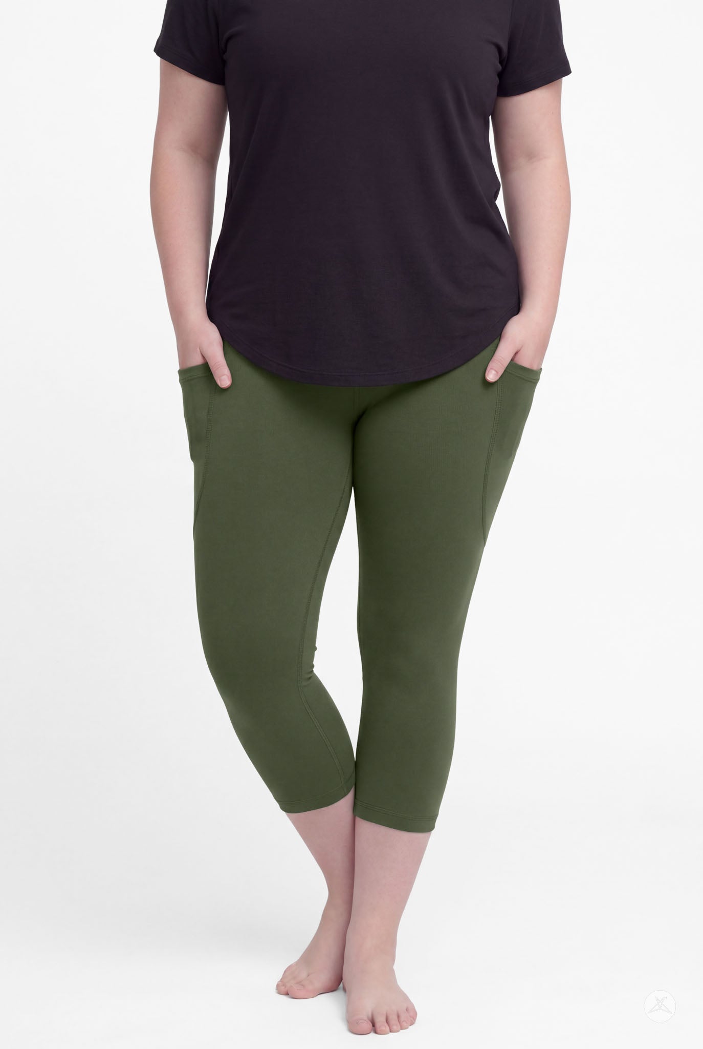 Woman wearing SweetLegs Cedar Pocket Crops in olive green with side pockets and black short sleeve top, barefoot