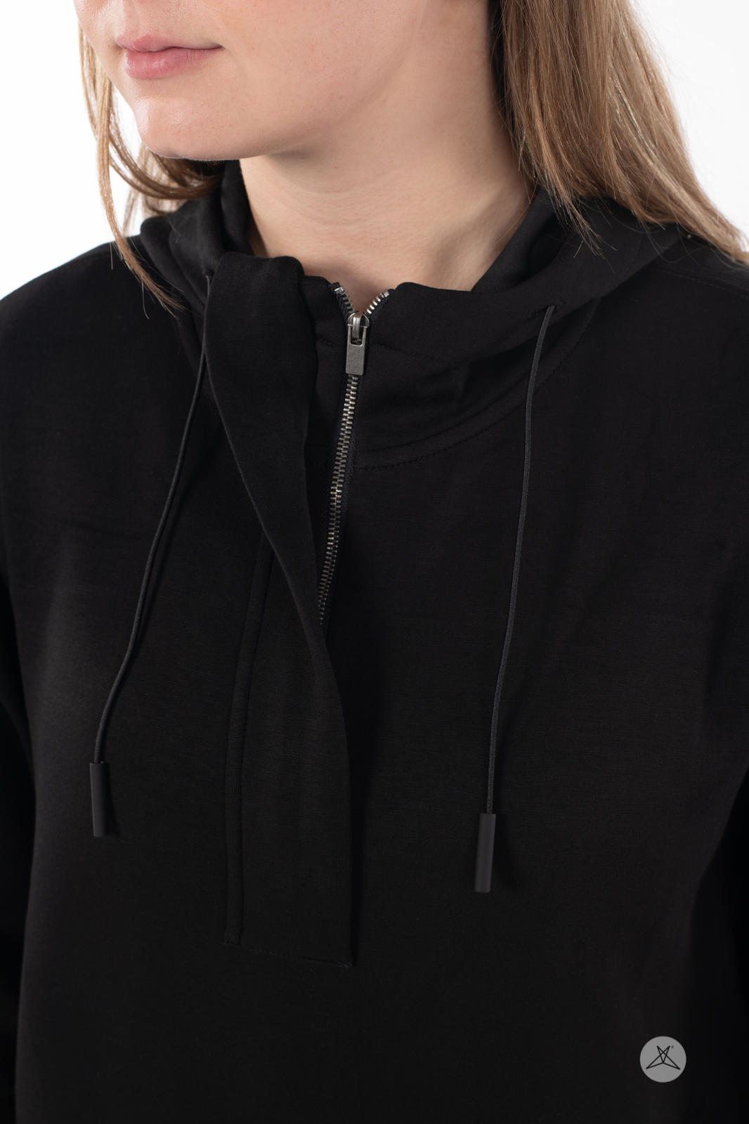 Close-up of a woman wearing black SweetTops All Day Hoodie with hidden half zipper and adjustable hood strings