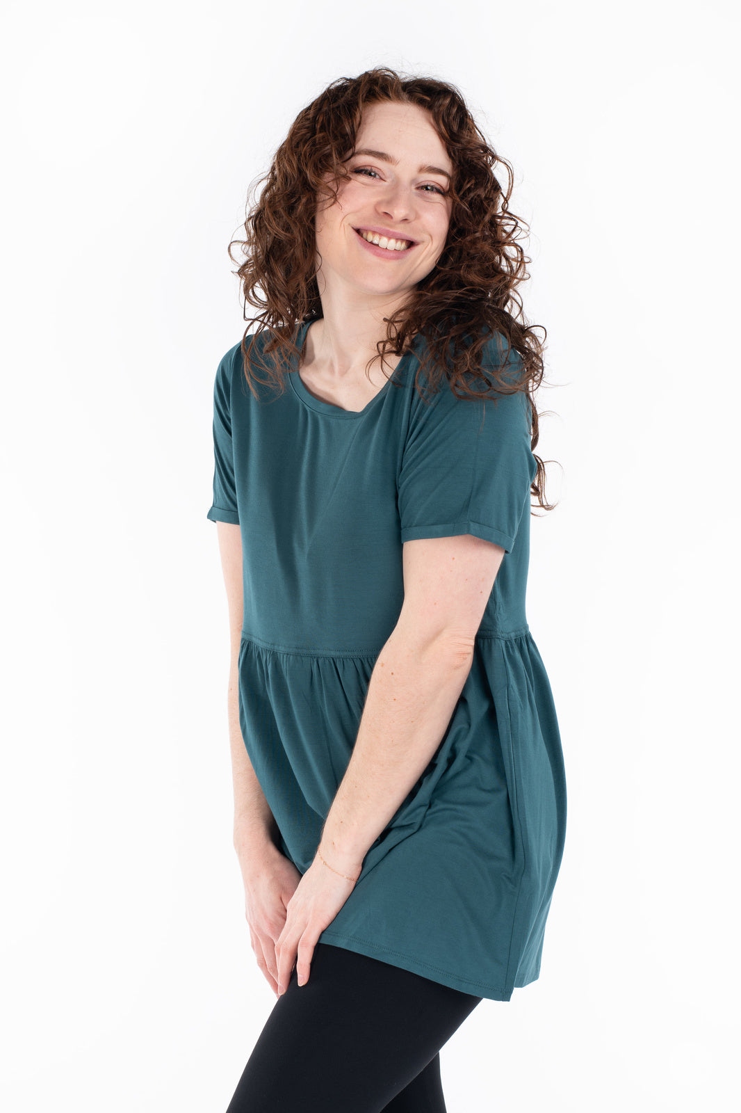Woman smiling wearing teal Babydoll Tee by SweetLegs Canada with short sleeves and relaxed babydoll fit front view