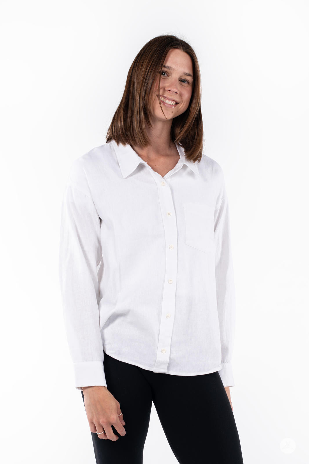 Smiling woman wearing SweetTops Classic Linen Shirt in white with button front and chest pocket on white background