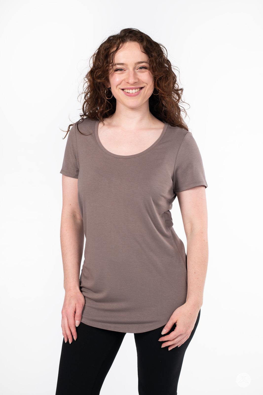Woman wearing SweetLegs Canada Scoop Neck Tee in soft taupe with curved hem and short sleeves smiling front view