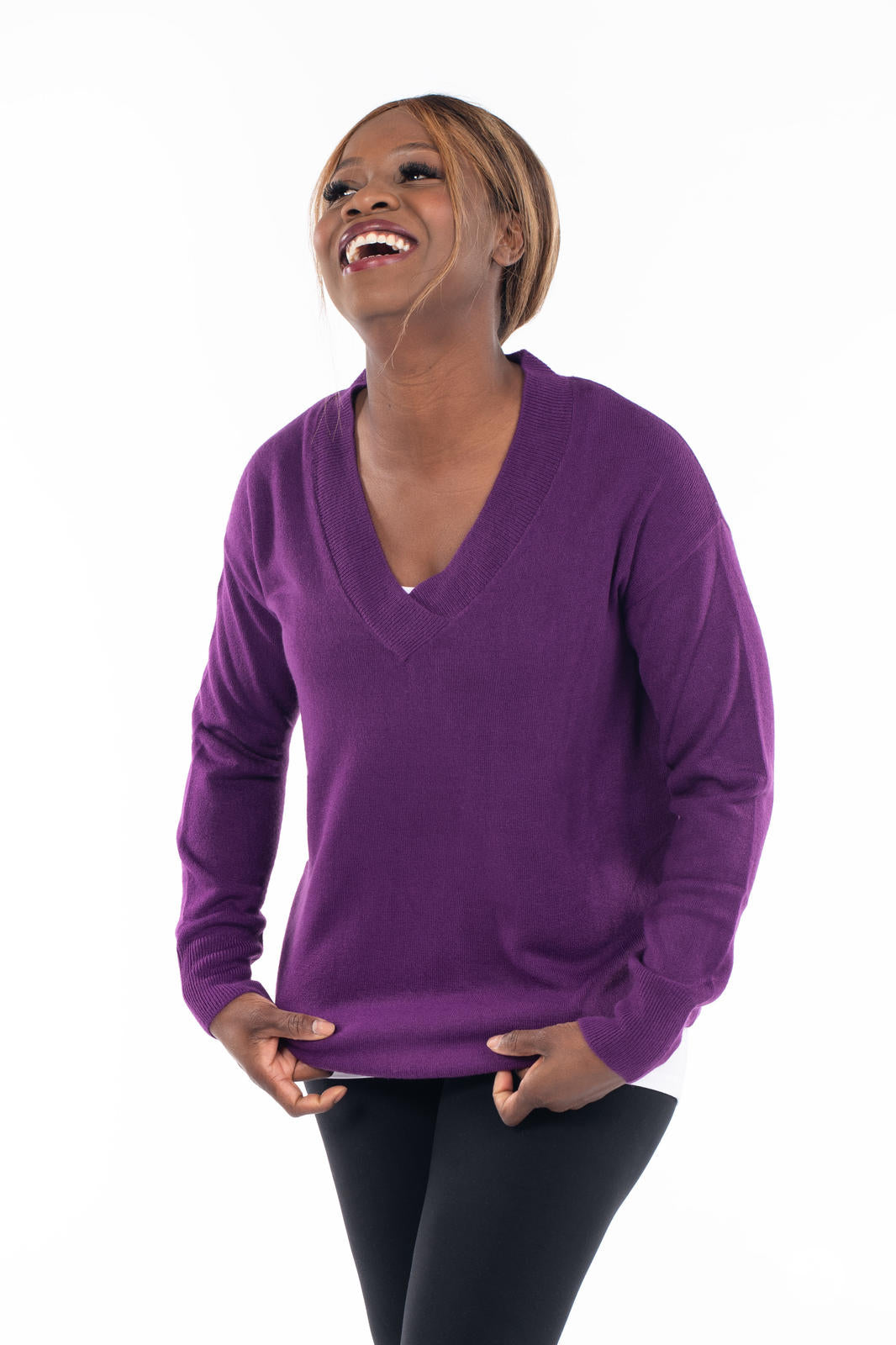 Woman smiling wearing SweetTops Soft Knit V-Neck Sweater in deep purple with relaxed fit and ribbed cuffs and hem