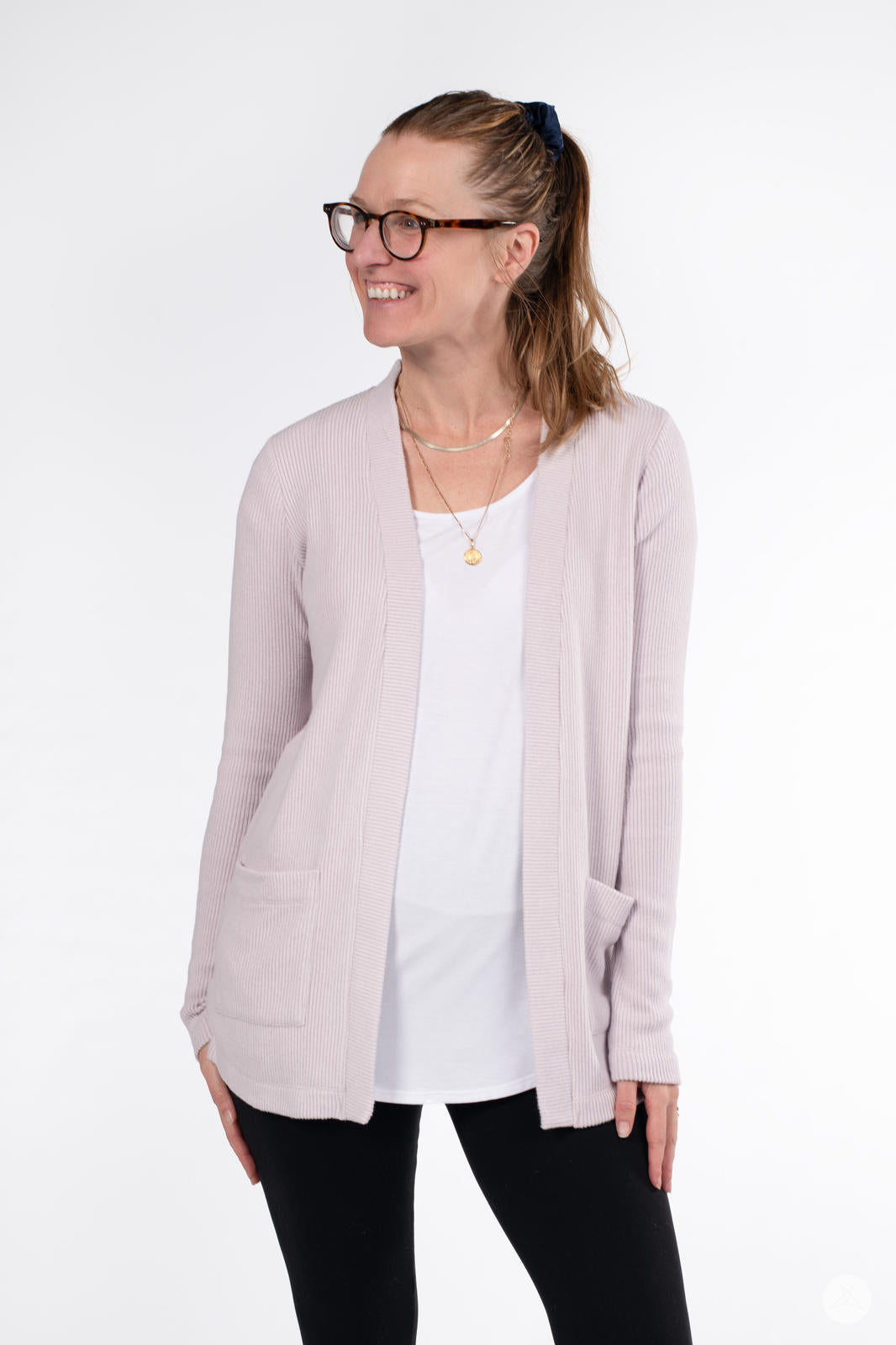 Woman smiling while wearing SweetLegs Canada Ribbed Comfort Cardigan in light dusty pink with front pockets and long sleeves
