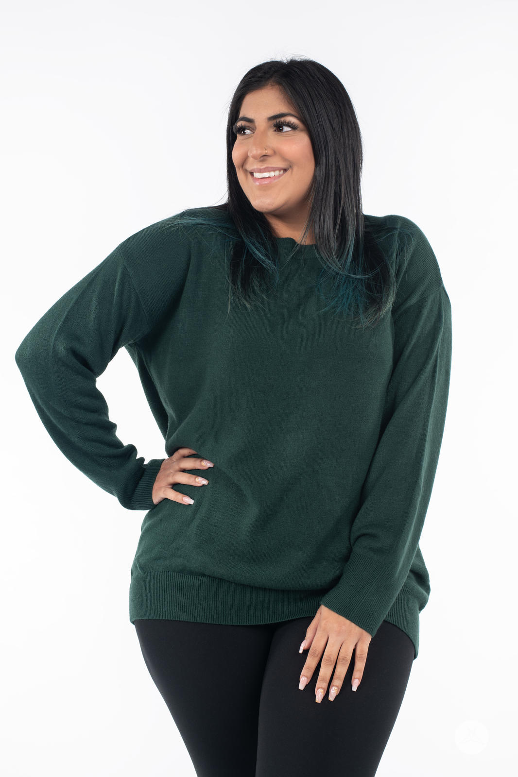 Woman smiling wearing SweetTops Soft Knit Crew Neck Sweater in forest green with relaxed fit and long sleeves