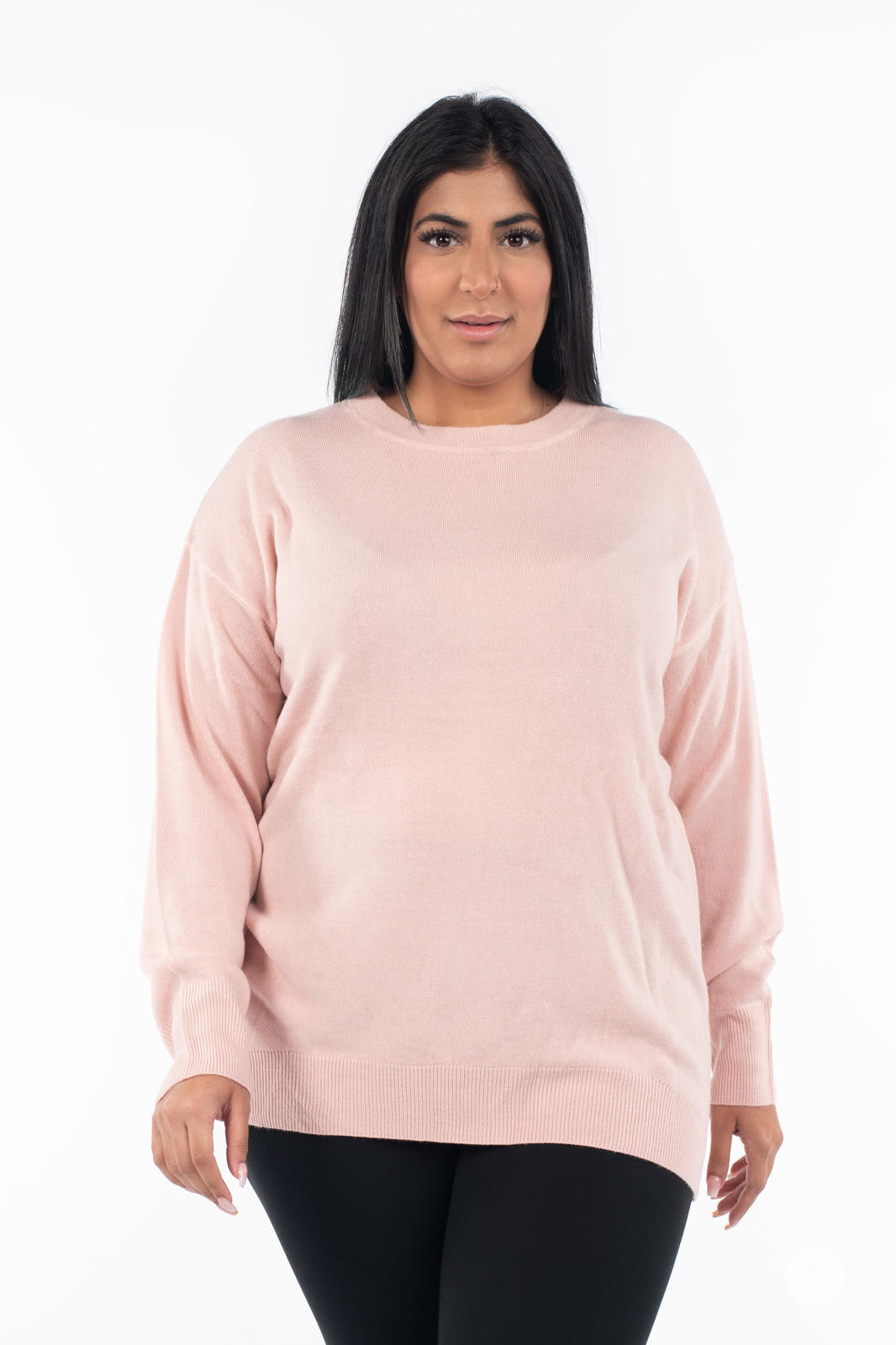 Plus size model wearing SweetTops Soft Knit Crew Neck Sweater in soft pink with relaxed fit and ribbed hem front view