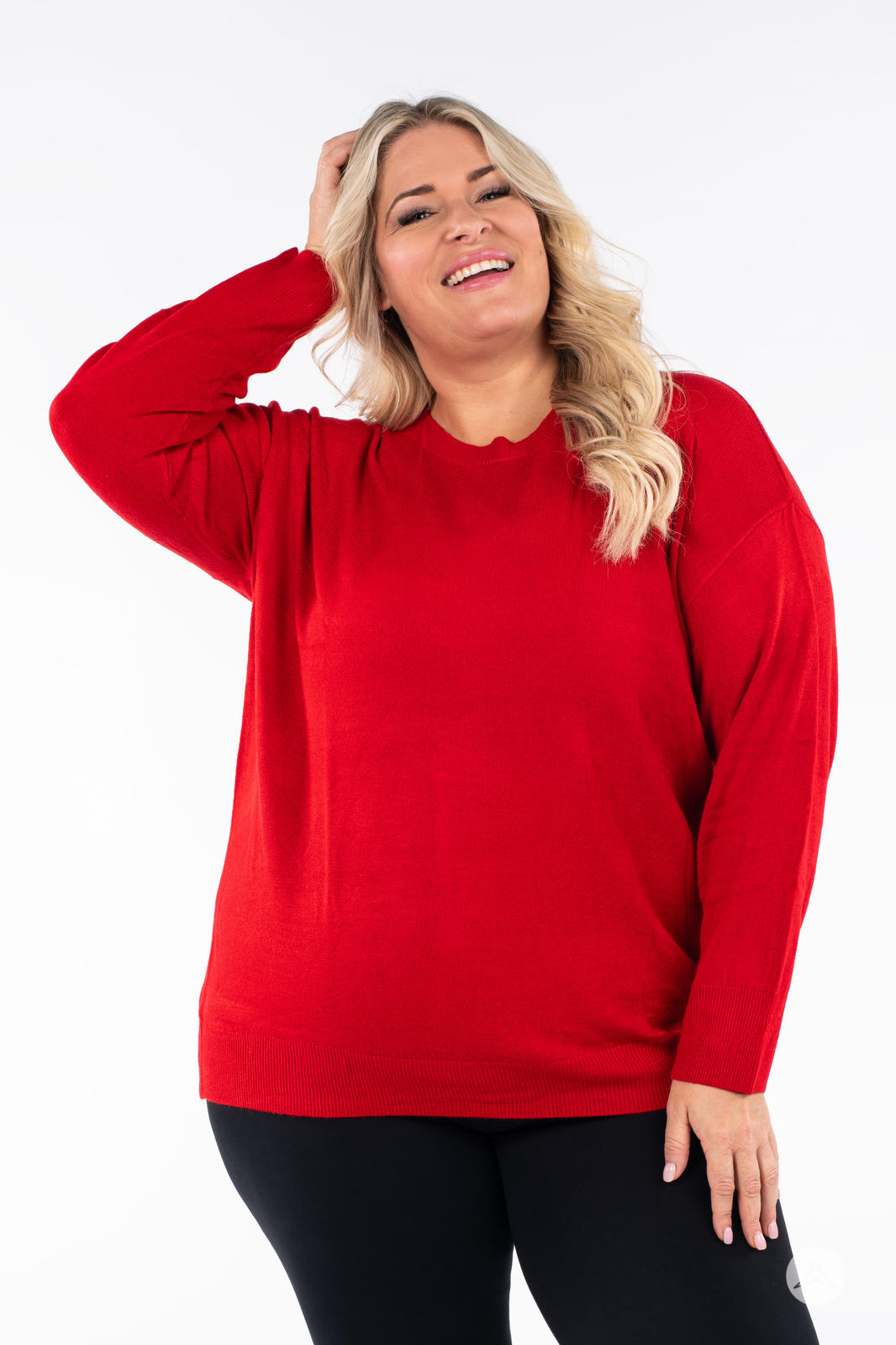 Smiling woman wearing SweetTops Soft Knit Crew Neck Sweater in red with relaxed fit and ribbed hem front view