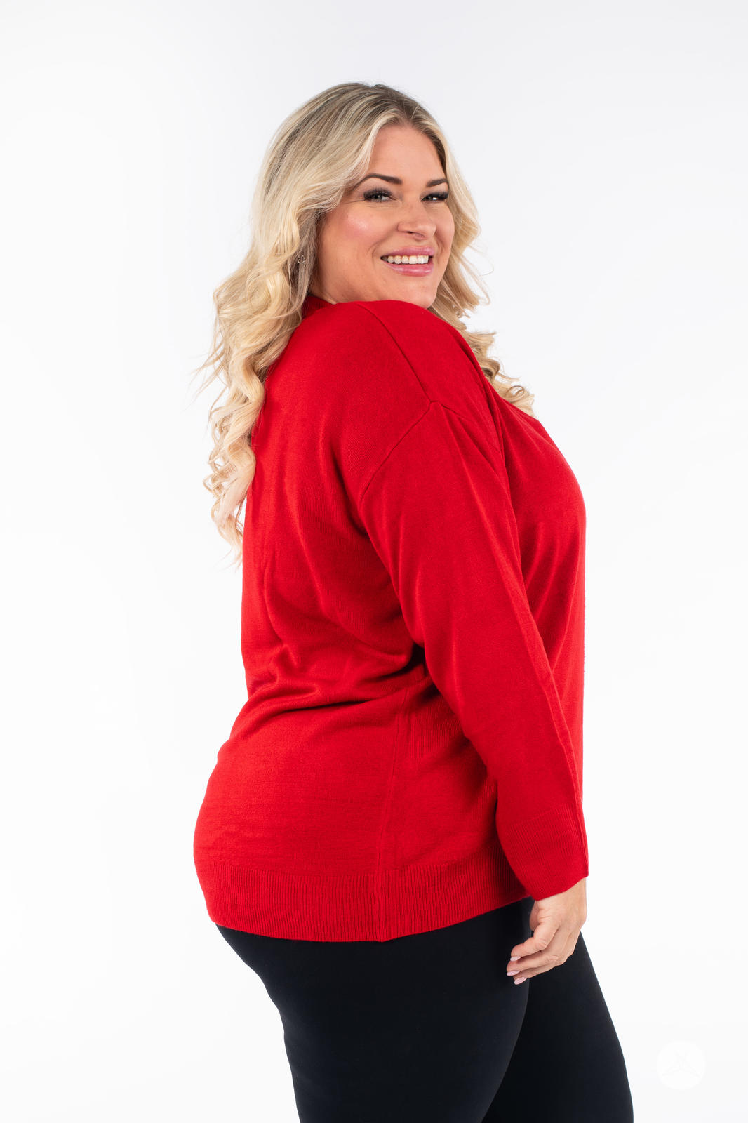Smiling woman in SweetTops Soft Knit Crew Neck Sweater in red with relaxed fit shown in side profile view