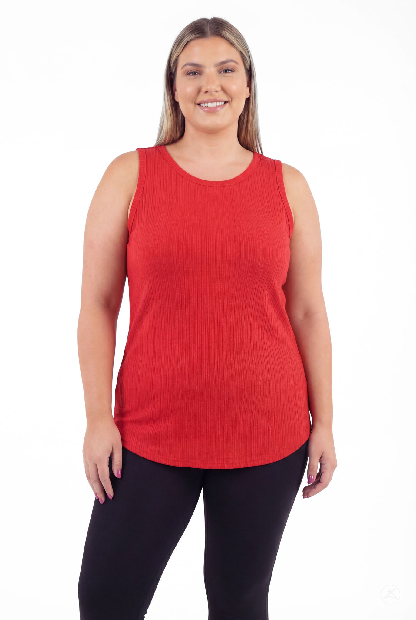 Plus size woman smiling wearing The Soft Ribbed Tank in vibrant red by SweetTops with ribbed fabric and sleeveless style