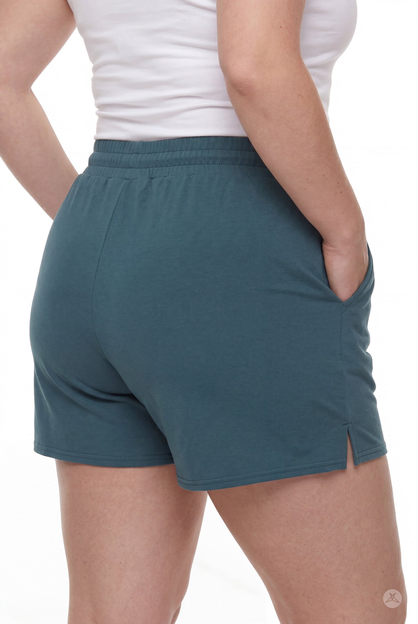 Rear view of person wearing teal Lounge Shorts by SweetLegs with elastic waistband, pockets, and small side slit
