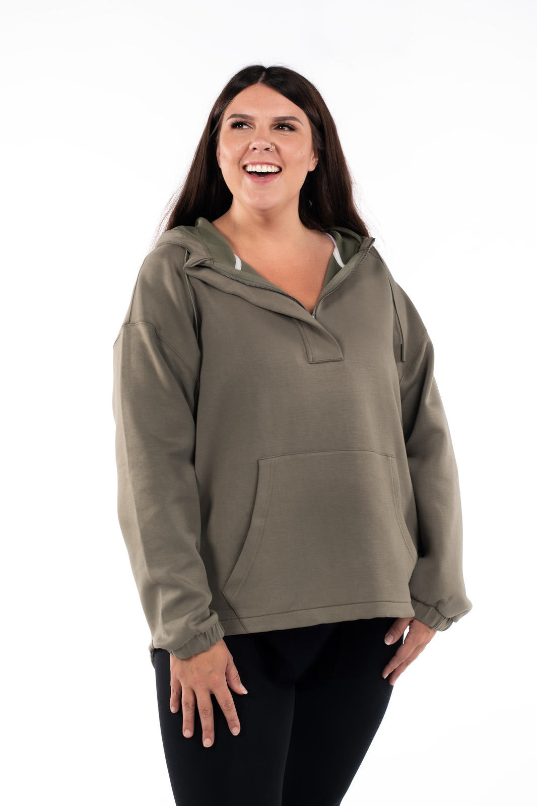 Plus-size model smiling wearing olive SweetTops All Day Hoodie with kangaroo pocket and half hidden zip on white background
