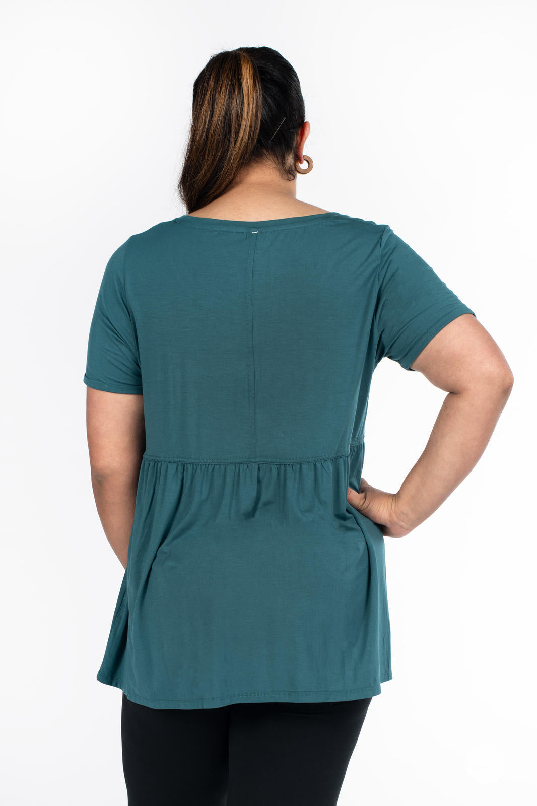 Woman shown from behind wearing teal Babydoll Tee by SweetLegs Canada with short sleeves and gathered babydoll waistline