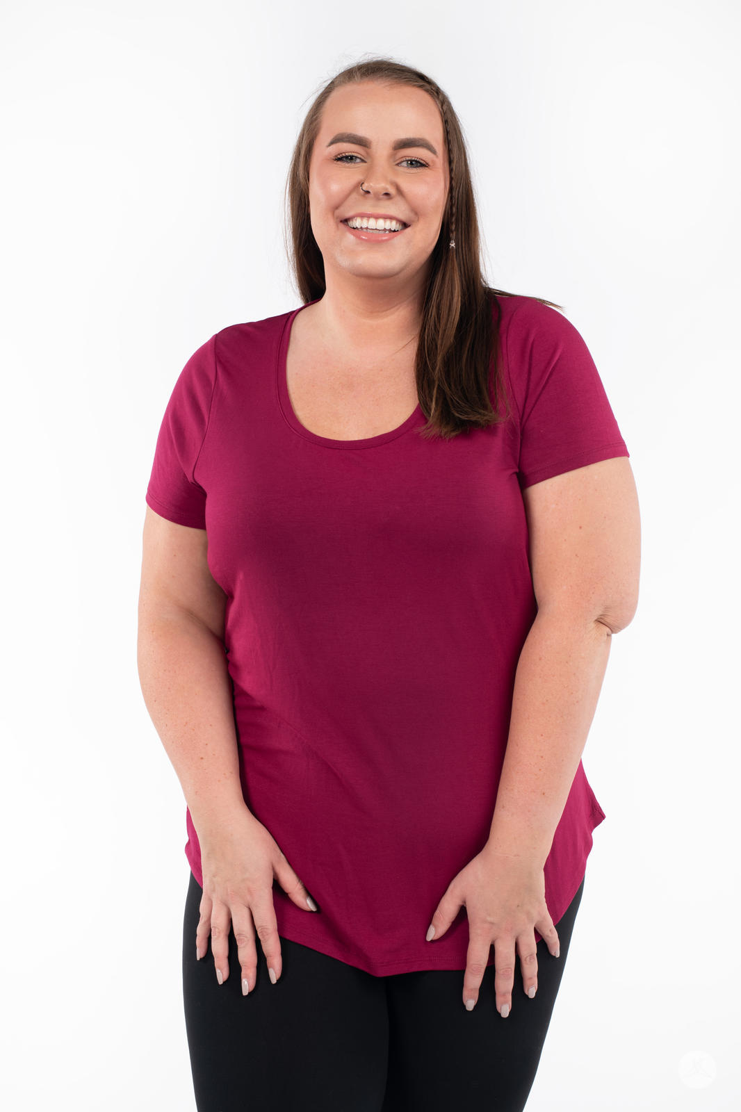 Smiling plus-size model wearing SweetLegs Canada Scoop Neck Tee in deep berry with short sleeves front view