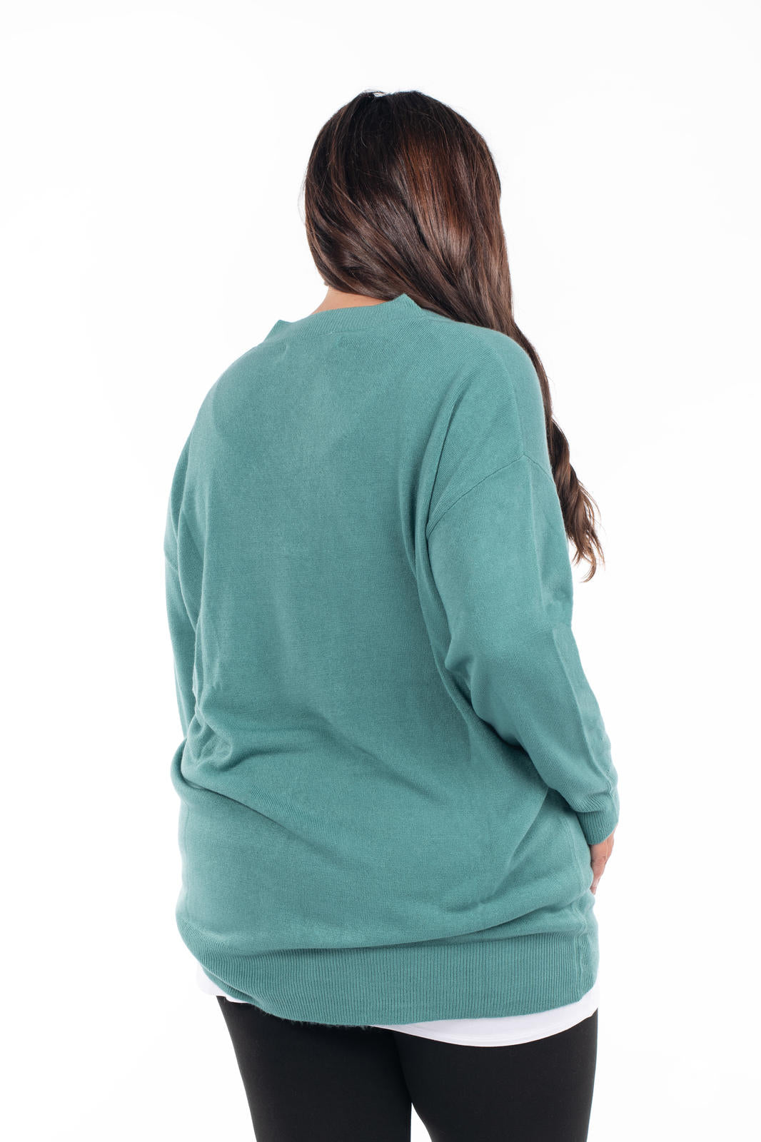 Back view of woman wearing SweetTops Soft Knit V-Neck Sweater in dusty teal with relaxed fit and ribbed hem