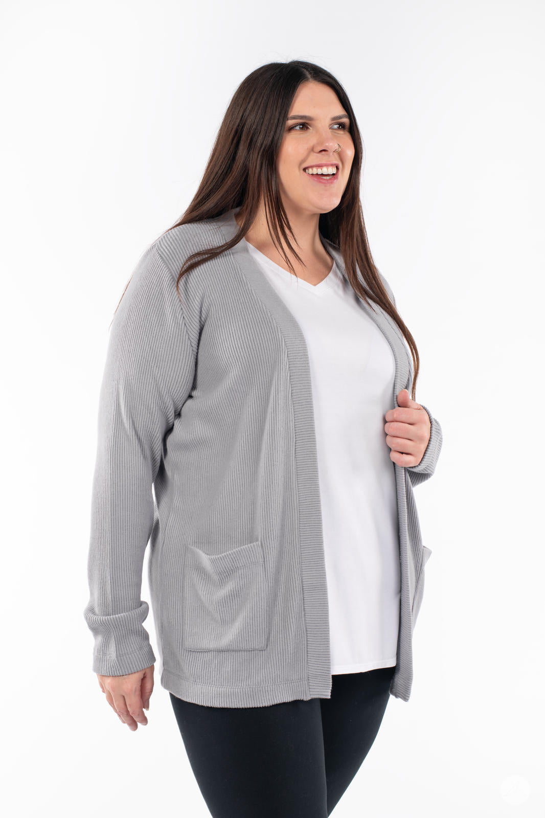 Plus-size woman smiling wearing SweetLegs Canada Ribbed Comfort Cardigan in grey with front pockets and relaxed open fit