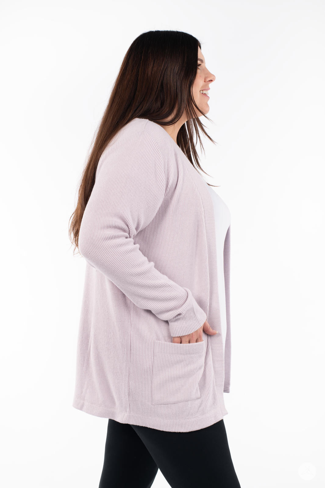 Side profile of woman wearing SweetLegs Canada Ribbed Comfort Cardigan in light dusty pink with front pocket and cozy fit