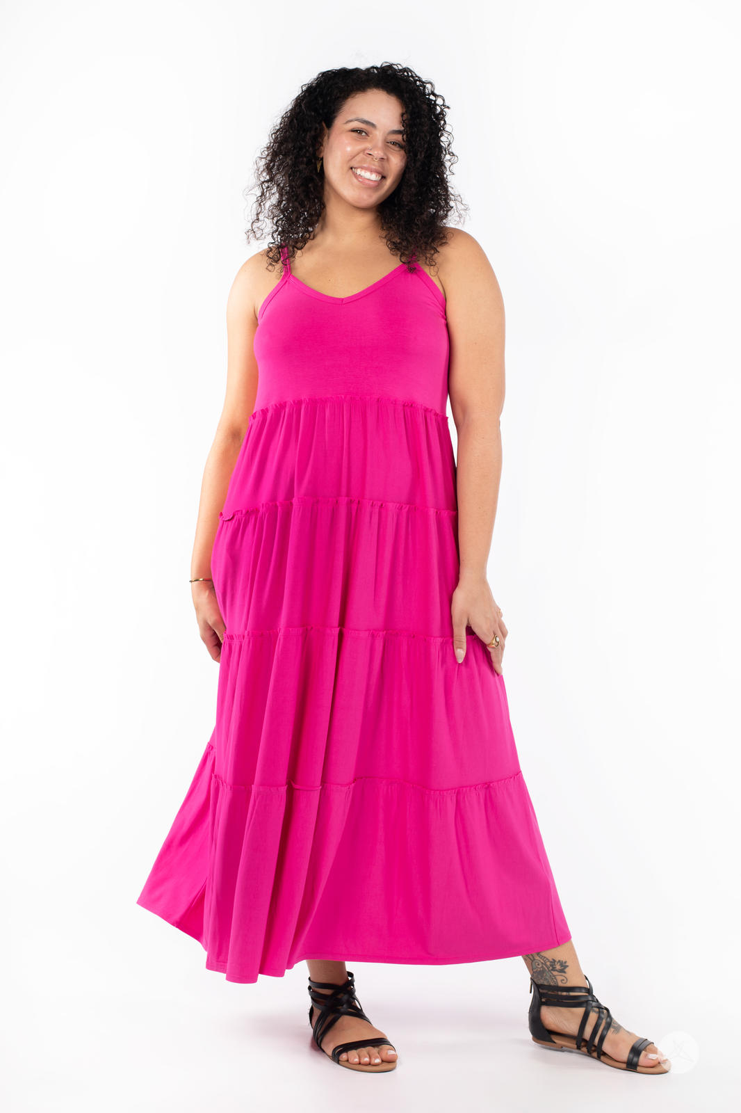 Plus-size model wearing SweetTops The Summer Tiered Dress in bright pink with adjustable straps and flowing maxi skirt