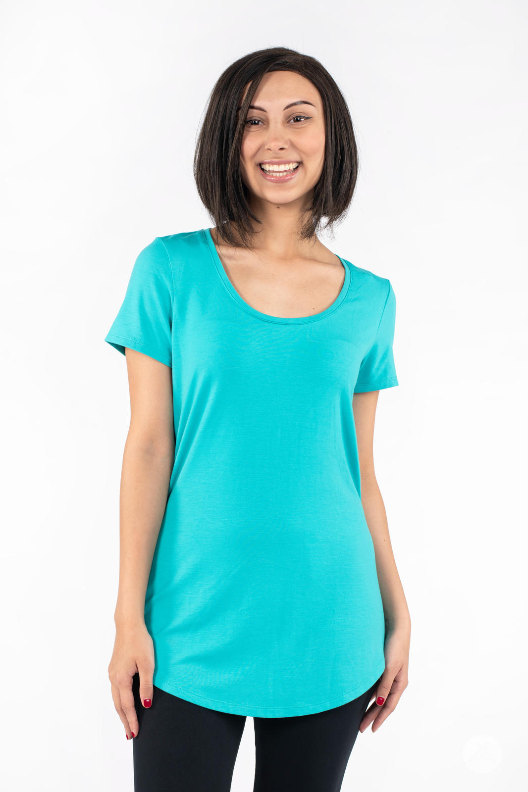 Smiling woman wearing SweetLegs Canada Scoop Neck Tee in turquoise with a curved hem front view standing