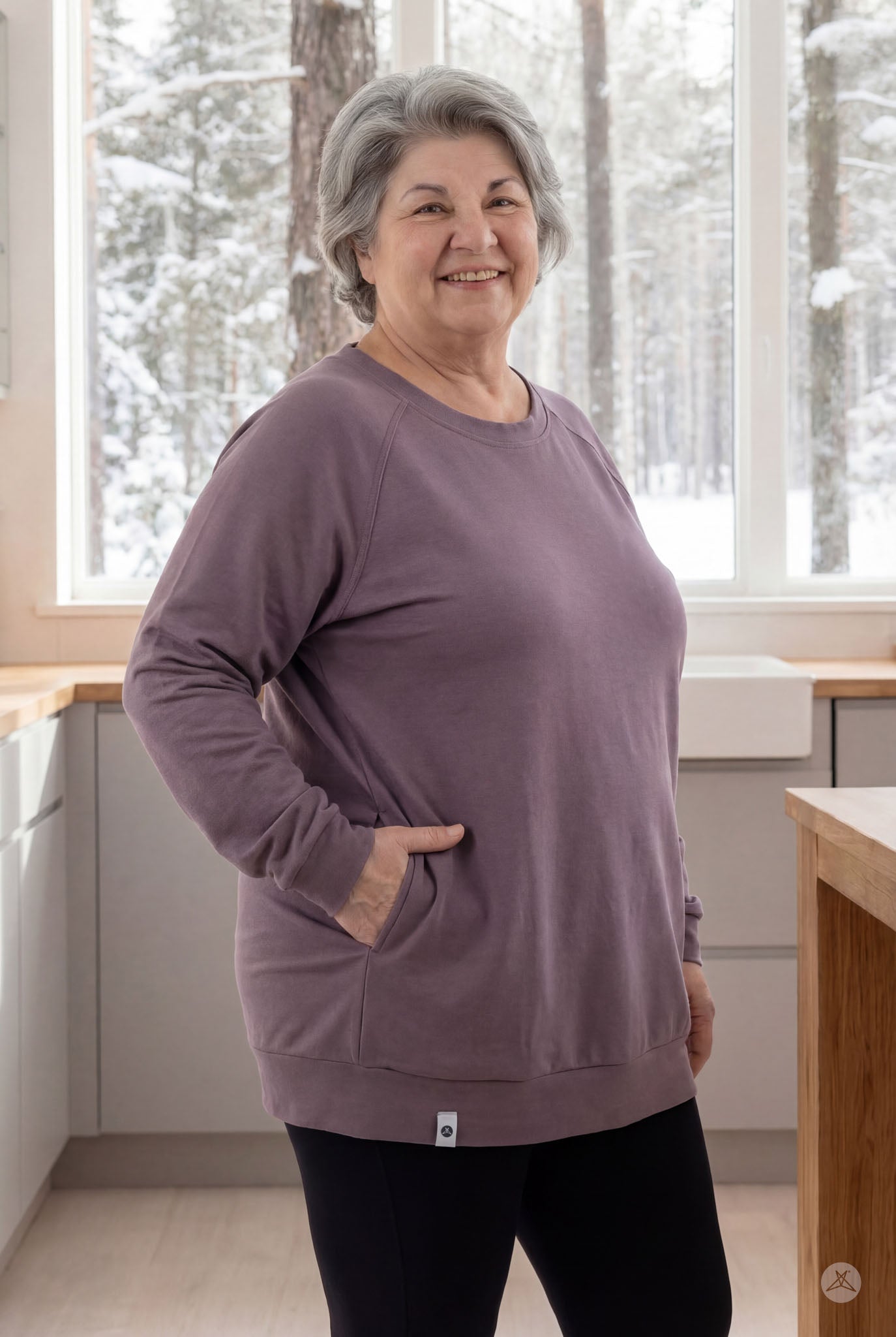Plus-size woman smiling while wearing mauve Basic Raglan Pullover by SweetLegs Canada with pocket in cozy indoor setting