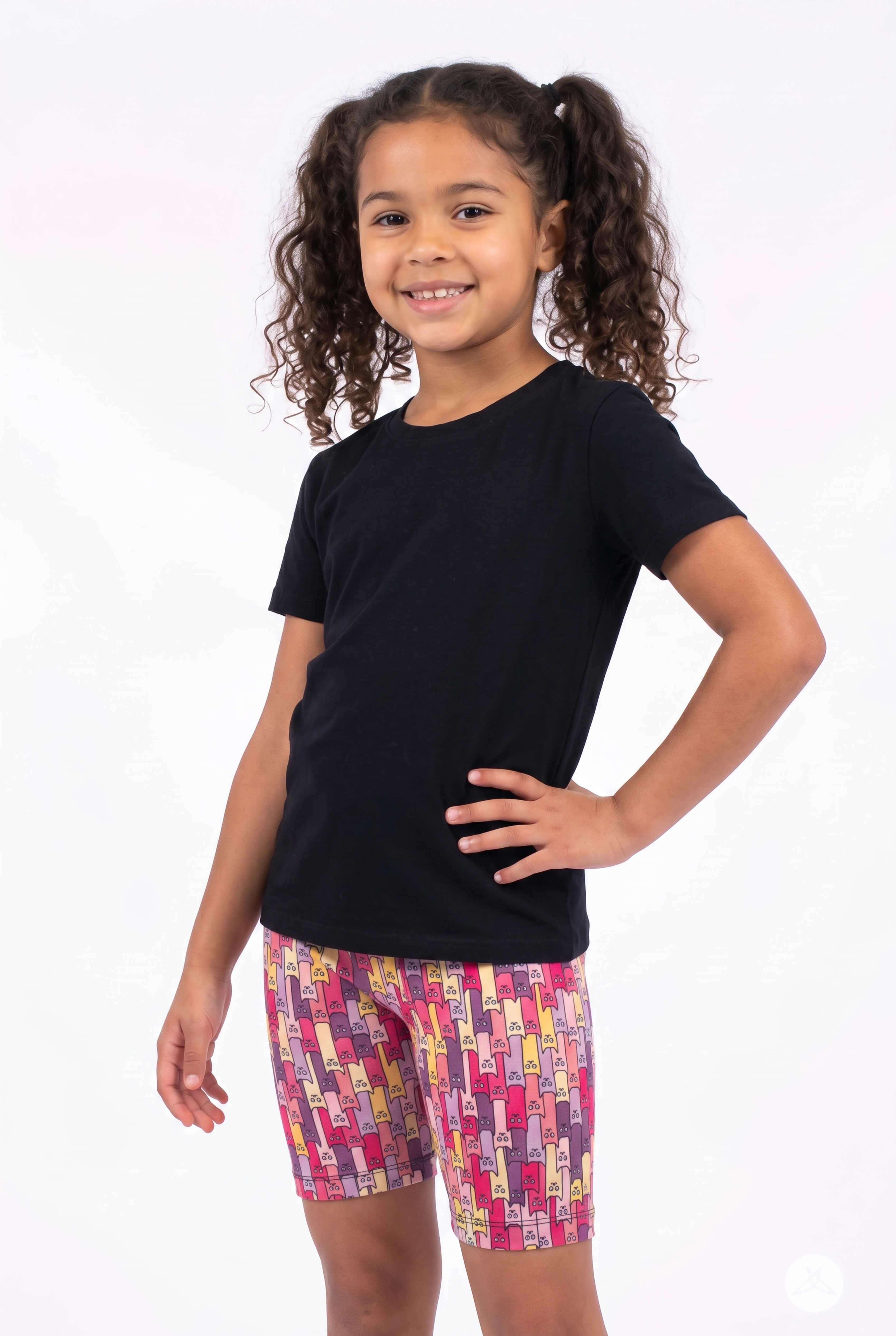 Child smiling wearing SweetLegs Cattitude Kids Biker Shorts | Perfectly Imperfect with colorful cat pattern and black top