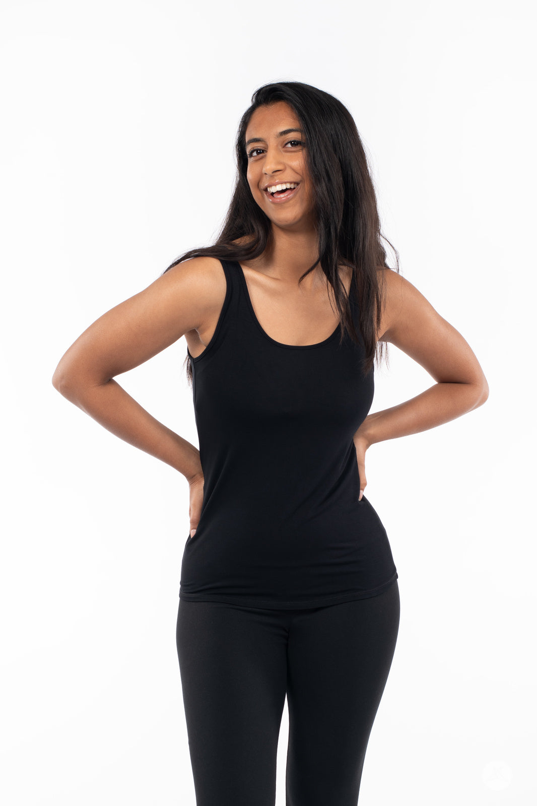 Smiling woman wearing SweetLegs Canada Classic Tank in black paired with black bottoms on white background