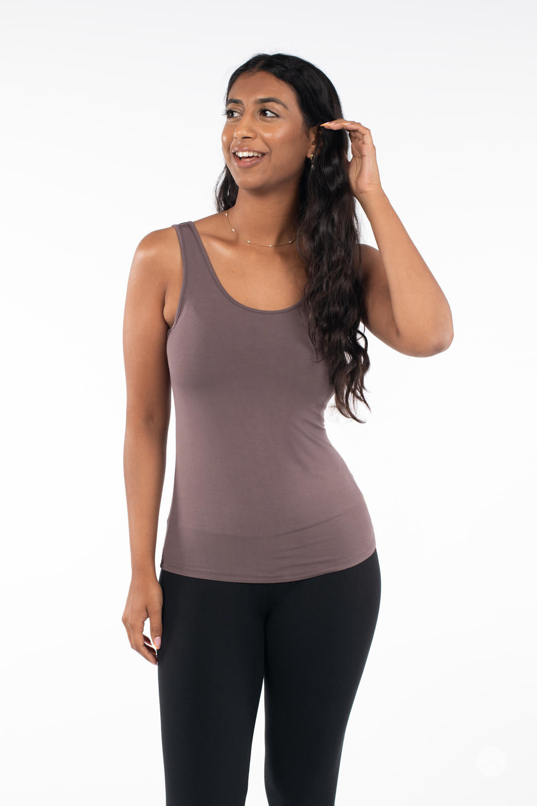 Woman wearing SweetLegs Canada Classic Tank in iron color paired with black leggings on white background
