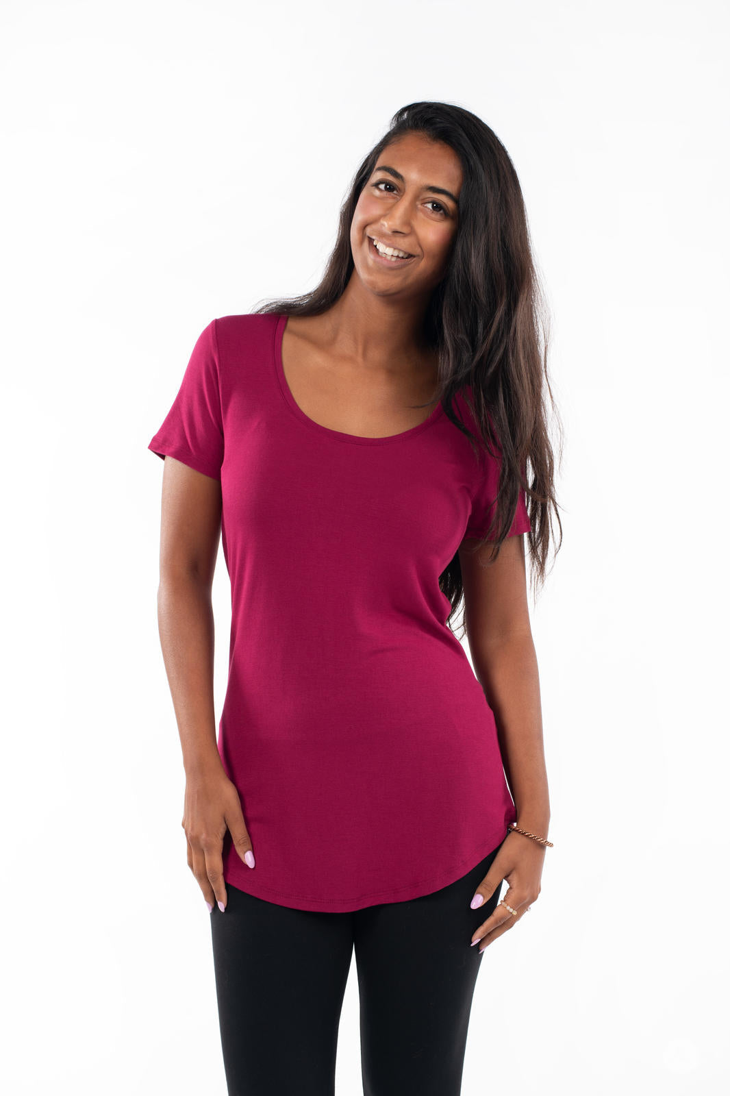 Smiling woman wearing SweetLegs Canada Scoop Neck Tee in deep berry with short sleeves and curved hem front view