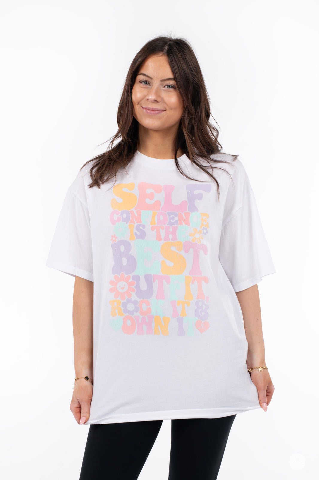 Smiling woman wearing SweetTops Vintage Graphic Tee in white with colorful retro text and positive affirmation design