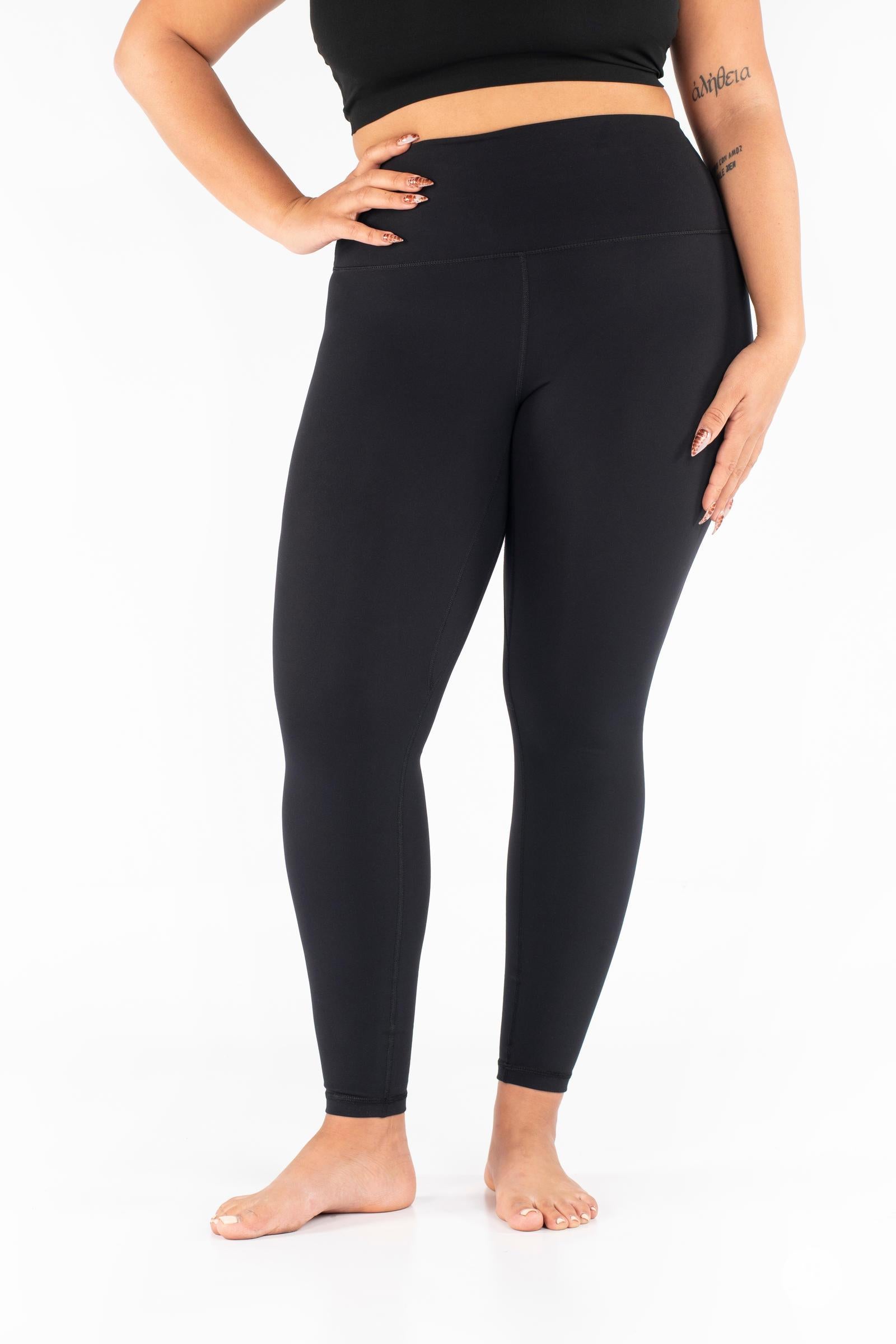 Plus-size woman wearing black Free Motion Leggings from SweetLegs Athleisure standing barefoot front view